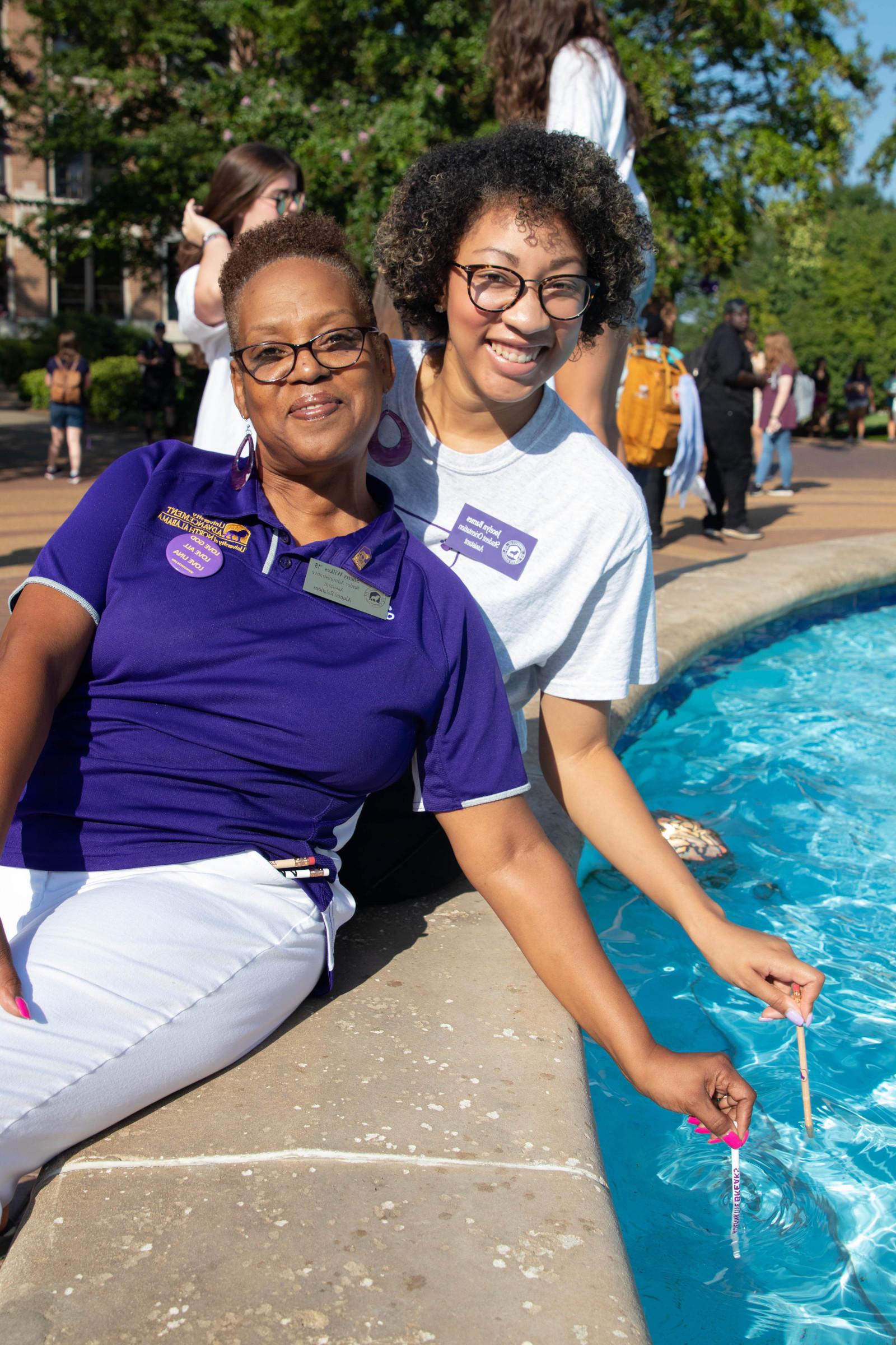 SOAR Counselor and Alumni Relations dipping their pencils in Harrison Fountain